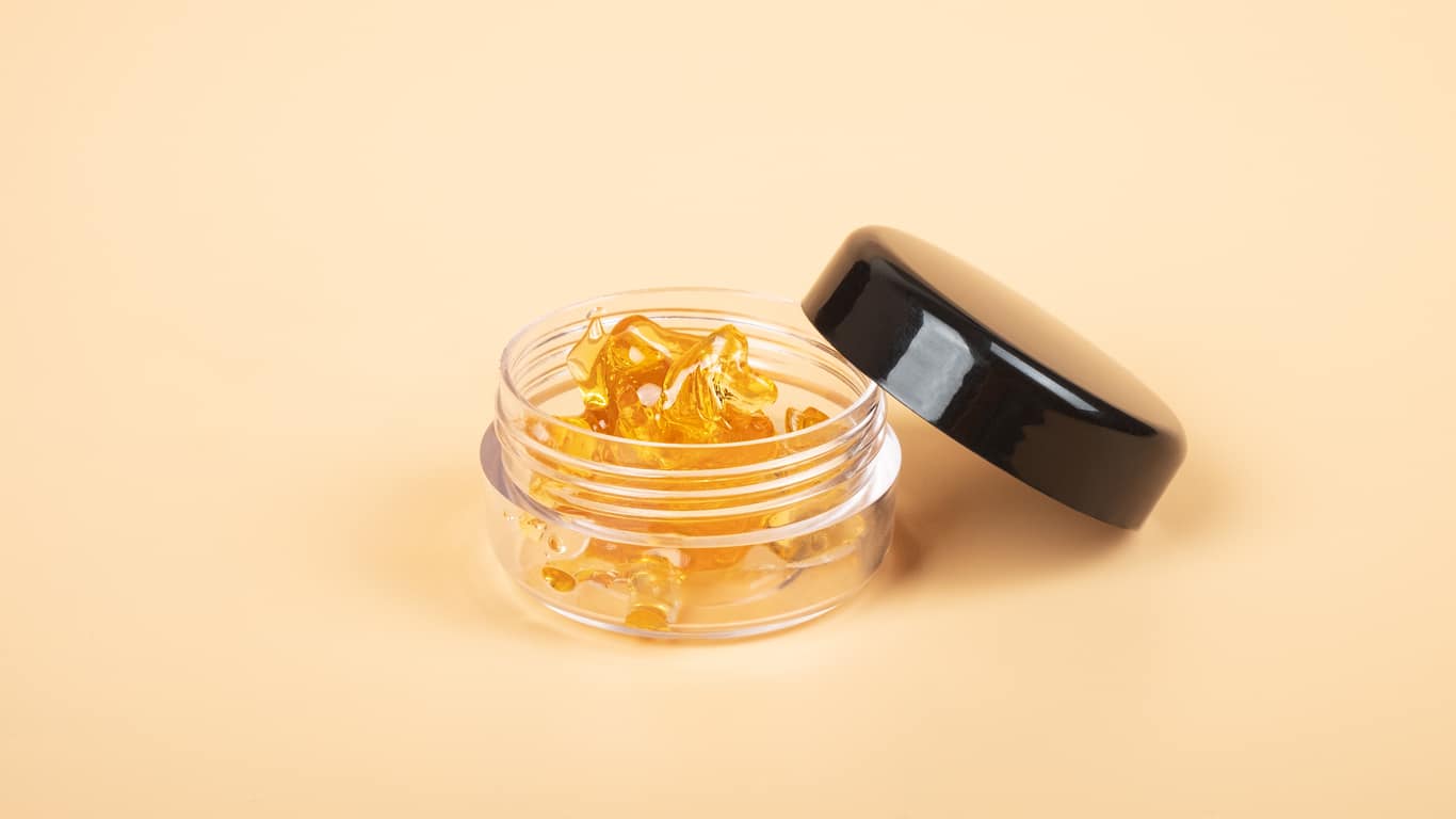 golden cannabis resin wax in a box, strong thc extract.